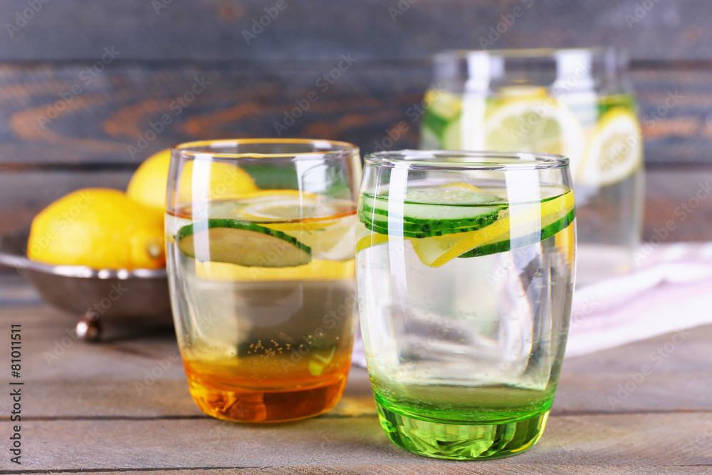 Fresh water with lemon and cucumber in glassware Fresh water with lemon and cucumber in glassware