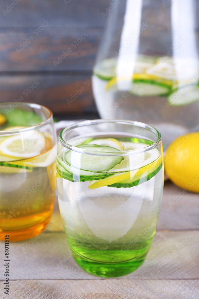 Fresh water with lemon and cucumber in glassware Fresh water with lemon and cucumber in glassware