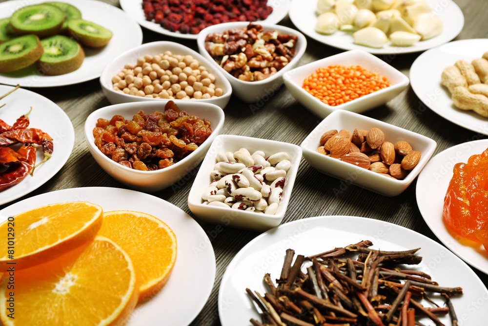Different products on saucers on wooden table, closeup Different products on saucers on wooden table, closeup