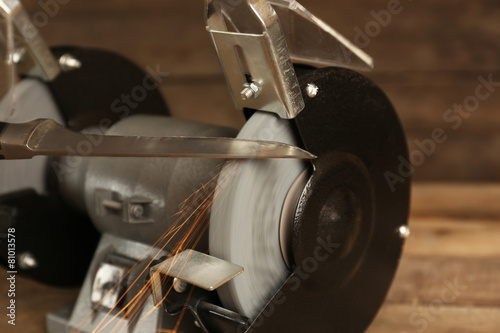 Knife sharpener on wooden table, closeup