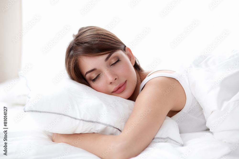 Beautiful girl sleeps in the bedroom, lying on bed Beautiful girl sleeps in the bedroom, lying on bed