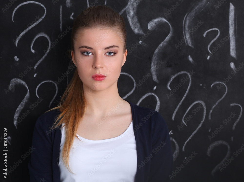 Young girl with question mark on a gray background Young girl with question mark on a gray background