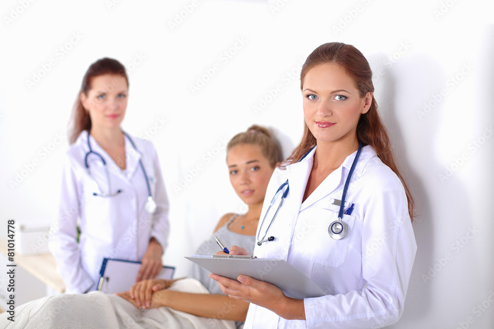 Smiling female doctor with a folder in uniform standing at Smiling female doctor with a folder in uniform standing at