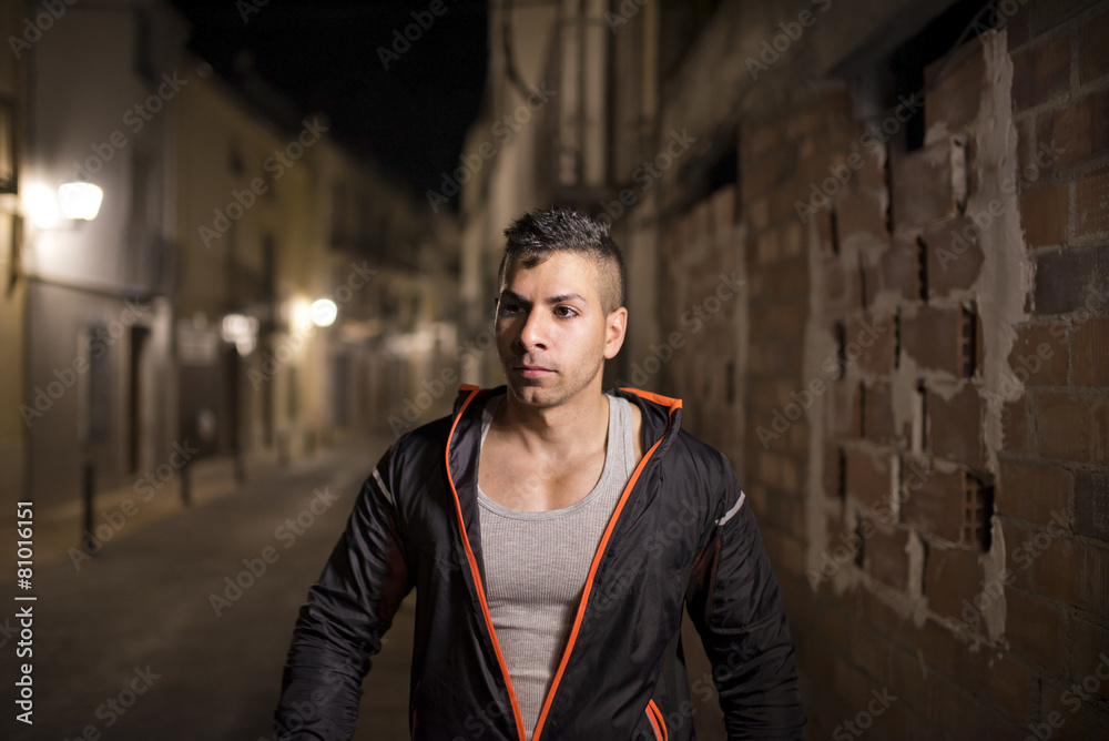 Fototapeta premium Young man in sportswear walking in street