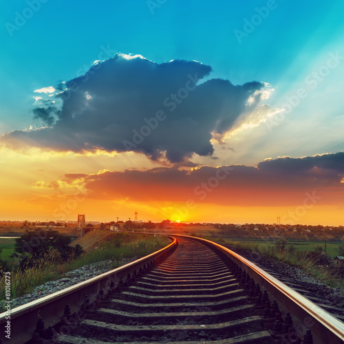 railway to horizon in sunset with low clouds