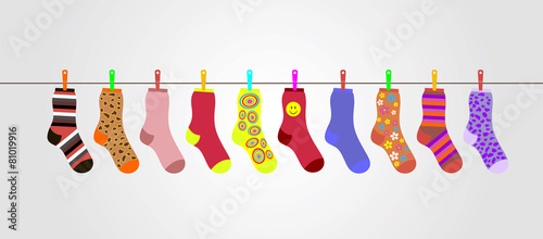 vector colorful socks on gray background are hanging on rope