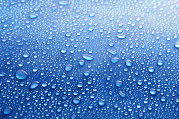 Water drops on glass on blue background