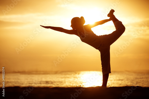 Photography Caucasian woman practicing yoga at seashore