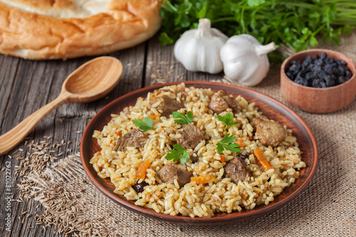 Traditional uzbek meal pilaf. Rice with meat, carrot and onion