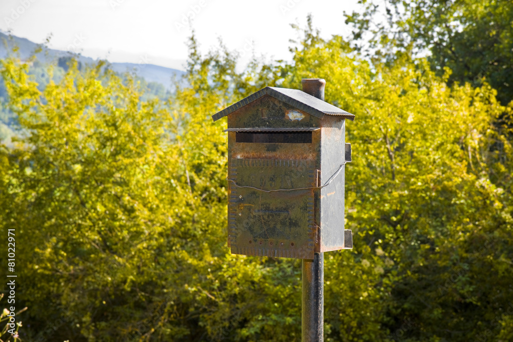 Old metal mailbox in the countryside. New ways of communication Old metal mailbox in the countryside. New ways of communication
