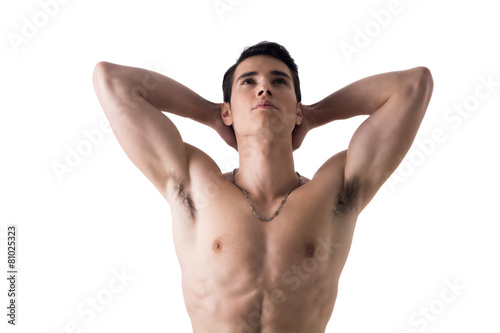 Attractive fit young man with hands behind head, isolated on