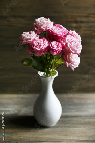 Bouquet of beautiful fresh roses on wooden background