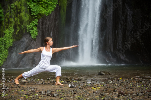 woman meditating doing yoga between waterfalls