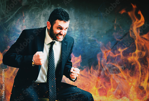young businessman in anger burning fire