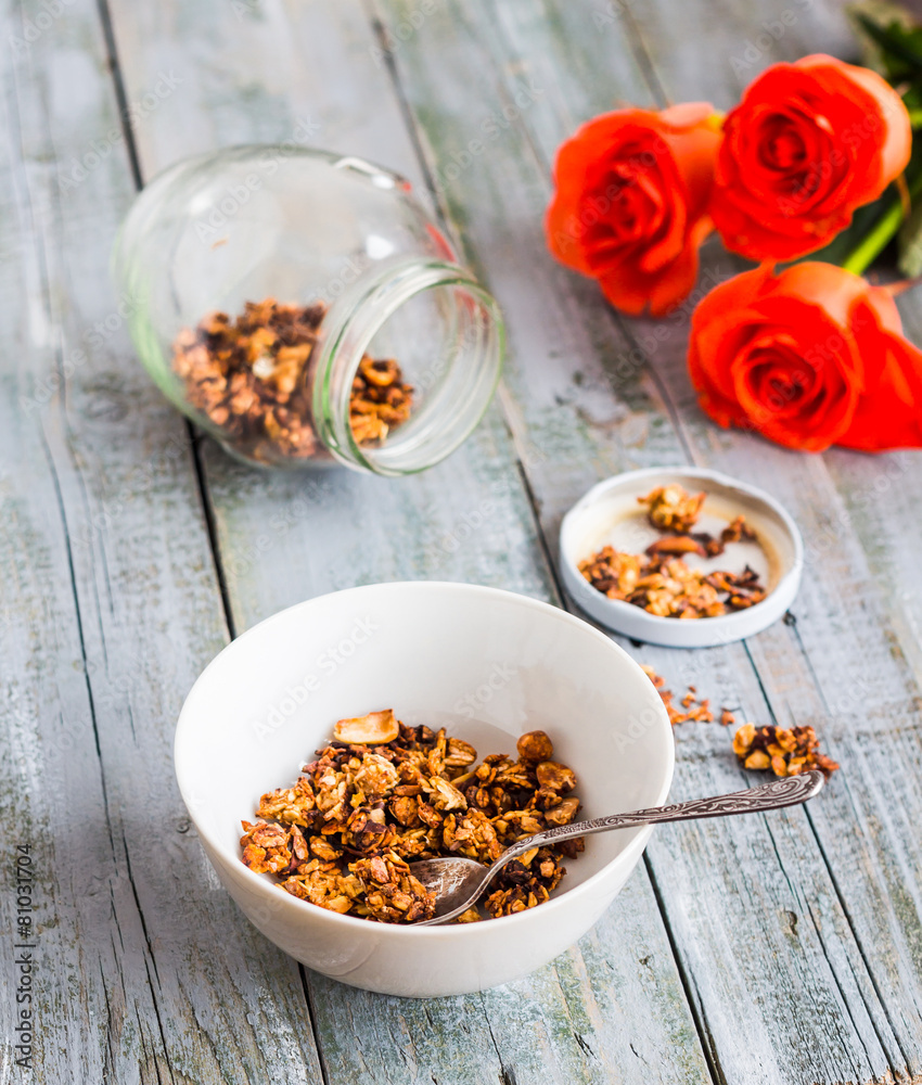 homemade granola with nuts and dried fruits, flowers homemade granola with nuts and dried fruits, flowers