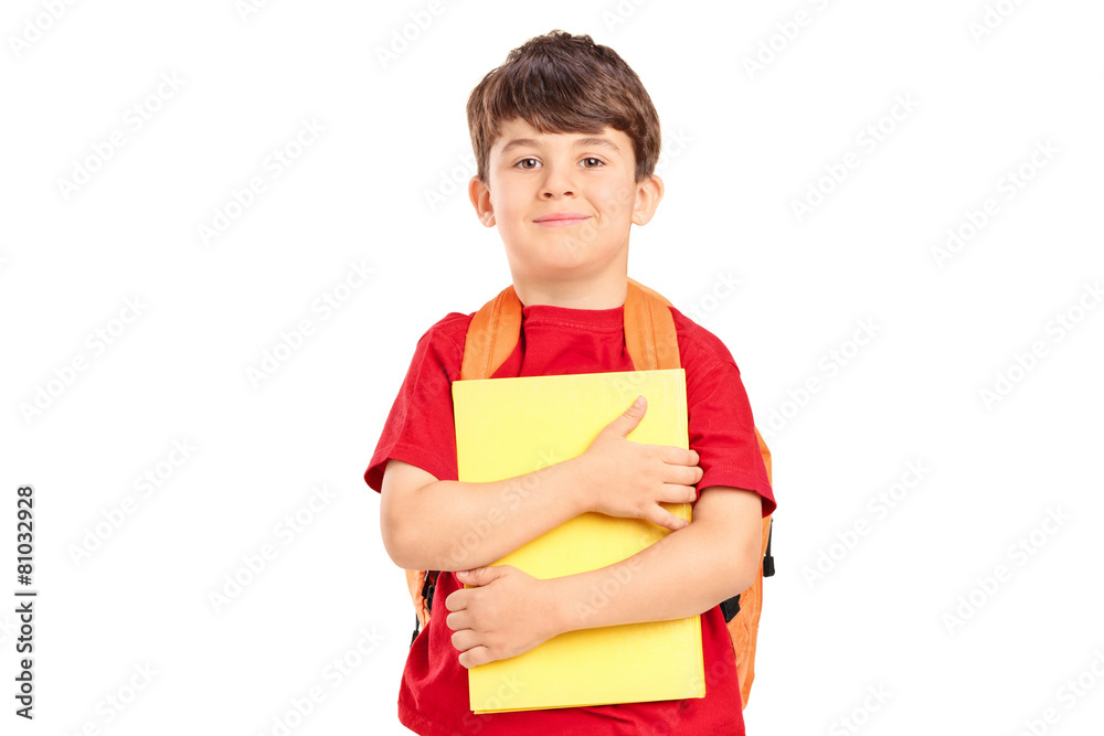 Smiling cute schoolboy with backpack holding books Smiling cute schoolboy with backpack holding books