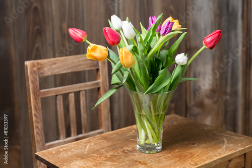 Fototapeta Naklejka Na Ścianę i Meble -  Coloful tulips in a vase on a wooden table