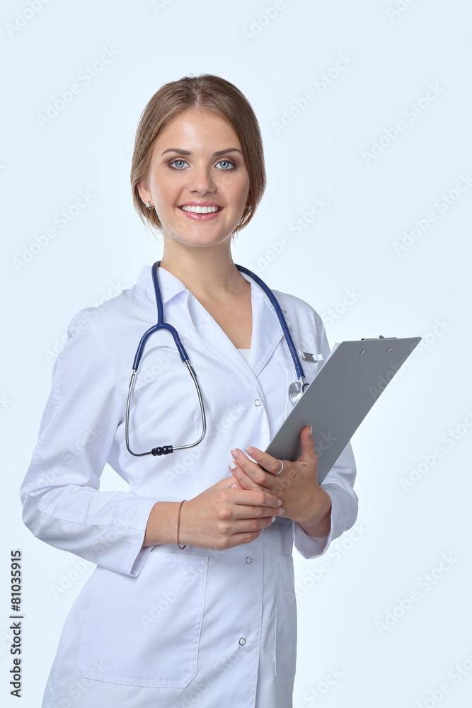 Smiling female doctor with a folder in uniform standing at Smiling female doctor with a folder in uniform standing at