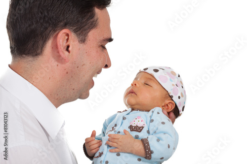 Acercamiento de un padre joven sonriendo y mirando con ternura a su bebé de un mes sobre fondo blanco photo