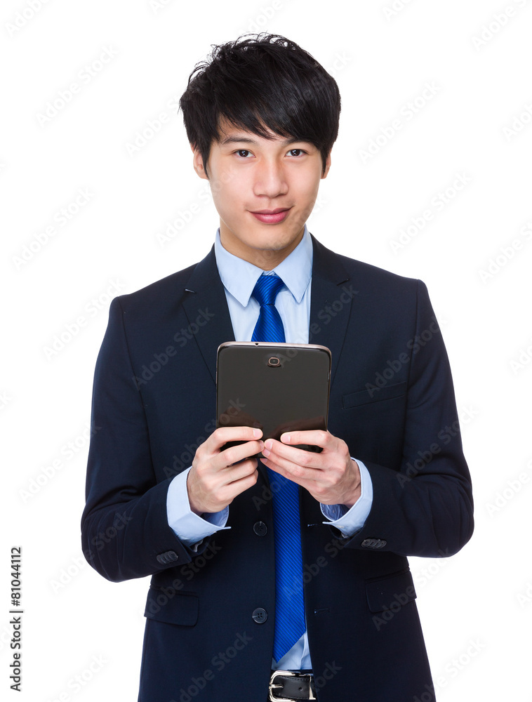 Young business asian man using his tablet Young business asian man using his tablet