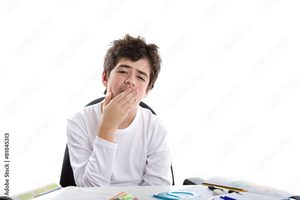Caucasian smooth-skinned boy yawning on homeworks Caucasian smooth-skinned boy yawning on homeworks