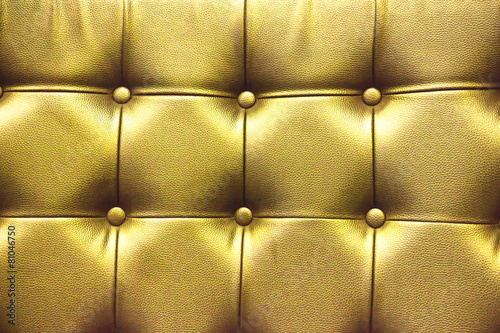 Closeup texture of vintage gold leather sofa for background