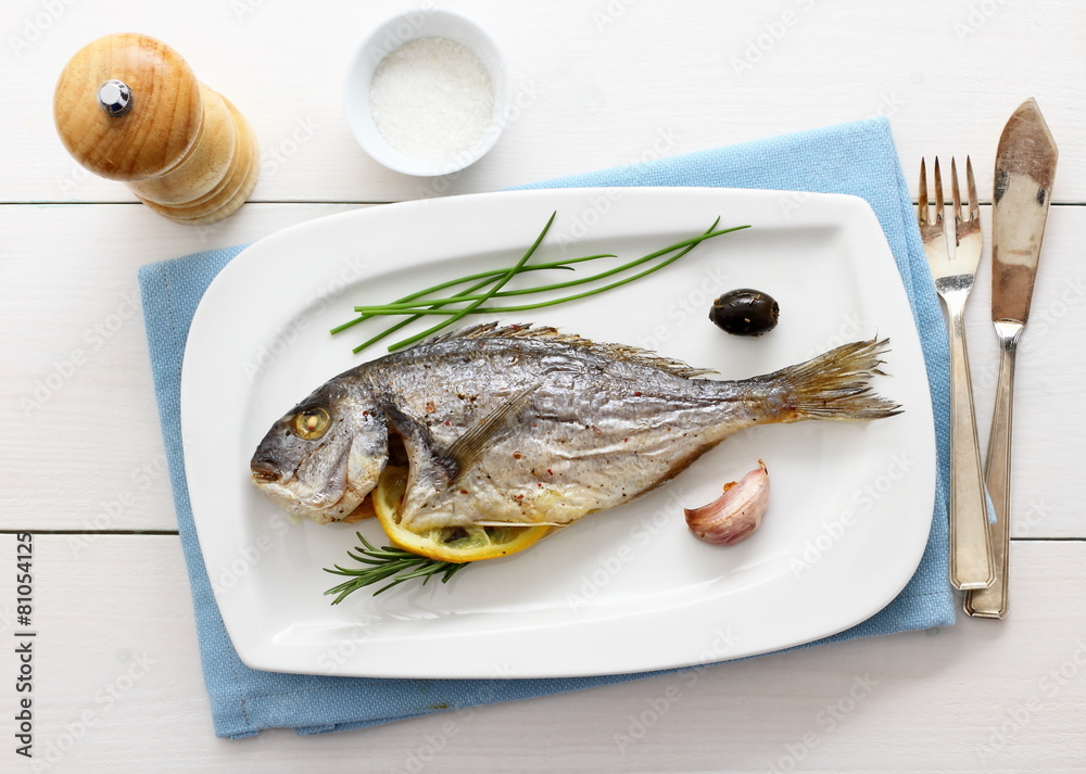 Garnished grilled whole sea bream with lemon Garnished grilled whole sea bream with lemon