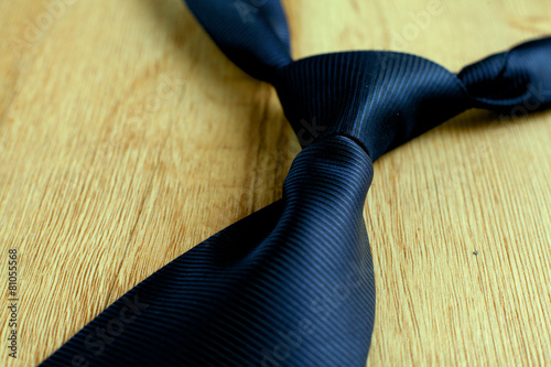 Elegant blue tie on a wooden background