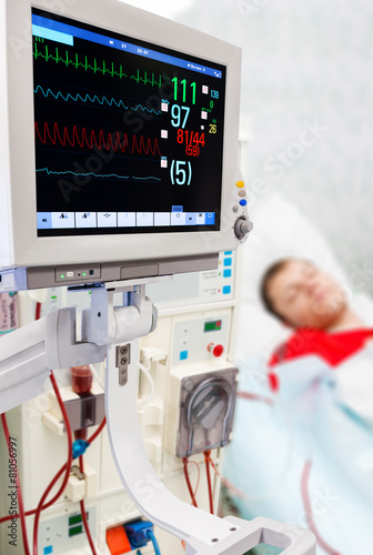 Patient at dialysis procedure with ECG monitor