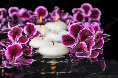 beautiful spa concept of geranium flower and candles in ripple r