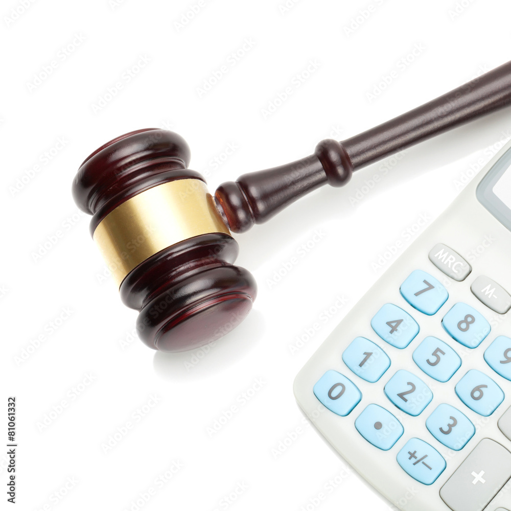 Gavel and neat calculator next to it - close up shot Gavel and neat calculator next to it - close up shot