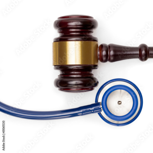 Judge gavel, pills bottle and stethoscope - studio shot