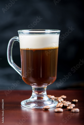 traditional strong irish coffee on wooden bar with coffee beans