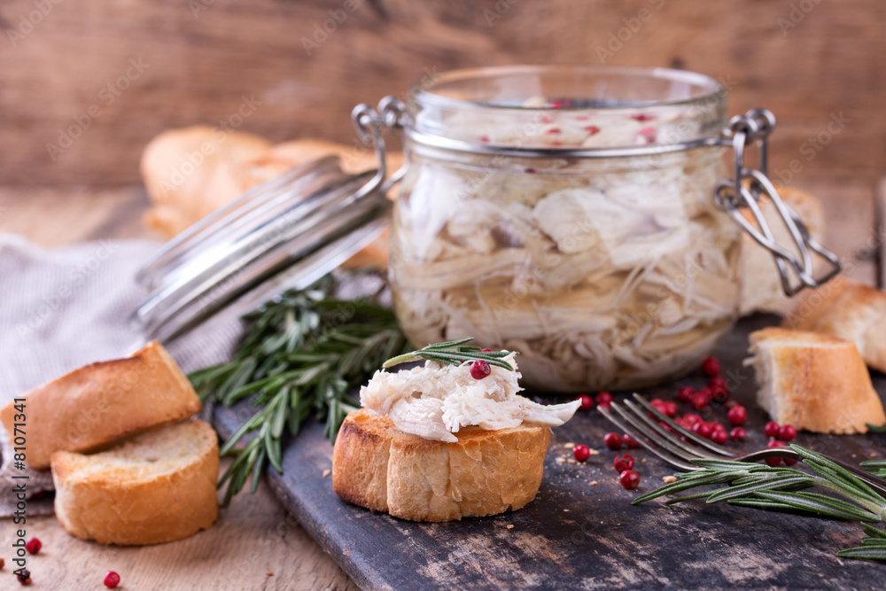 Chicken pate in glass jar and toast bread on rustic board Chicken pate in glass jar and toast bread on rustic board