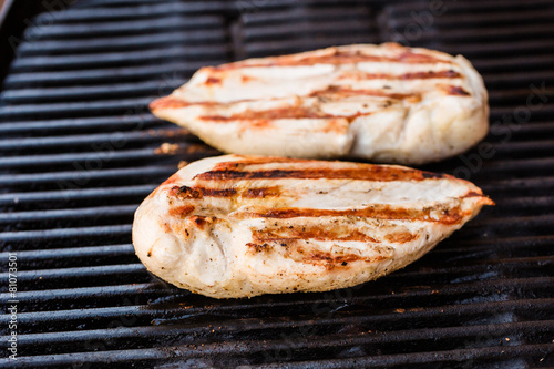 Grilled chicken breast fillets on BBQ