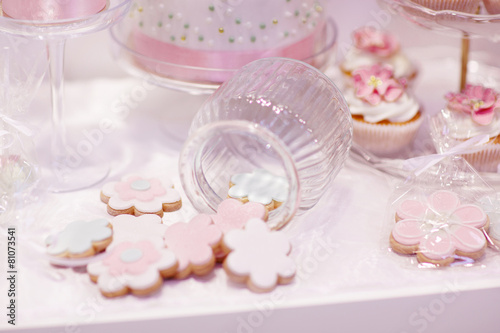 Elegant sweet table with cupcakes and other sweets for dinner or