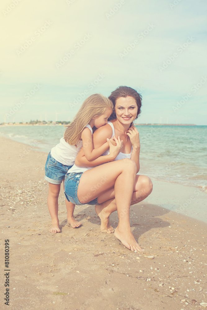 Mother and her daughter having fun on the beach Mother and her daughter having fun on the beach