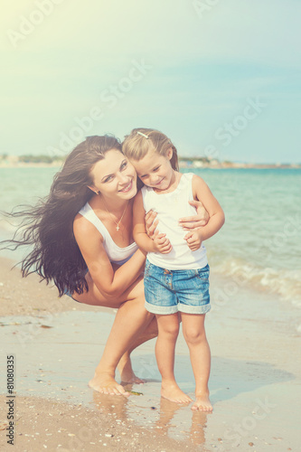 Happy beautiful mother and daughter enjoying beach time © Malsveta