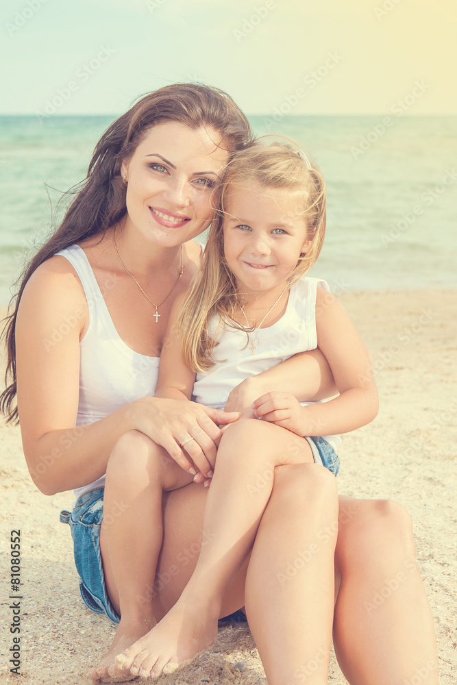 Mother and her daughter having fun on the beach Mother and her daughter having fun on the beach