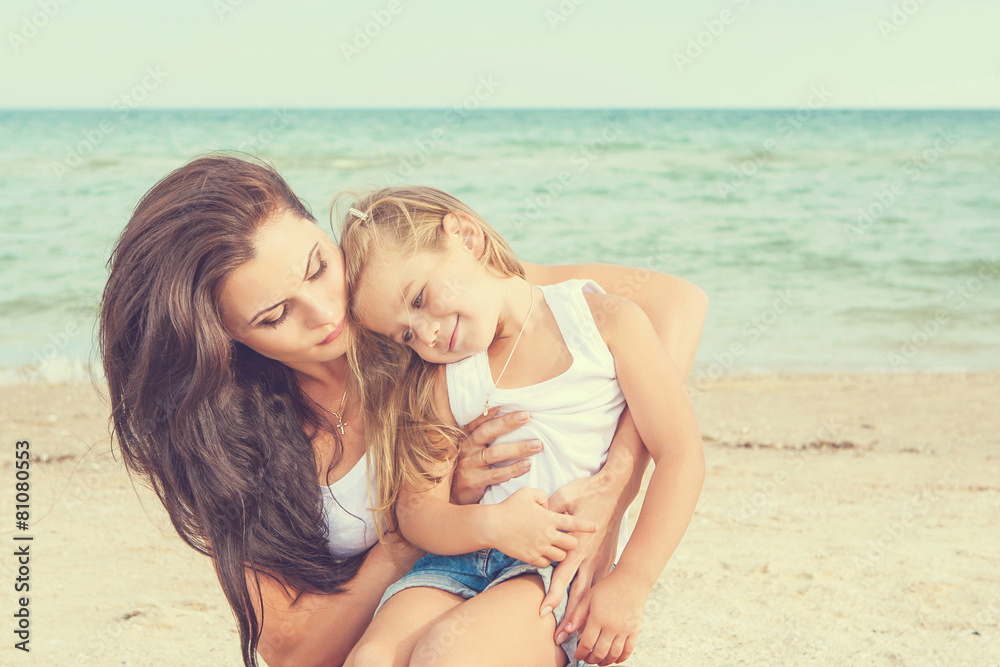 Mother and her daughter having fun on the beach Mother and her daughter having fun on the beach