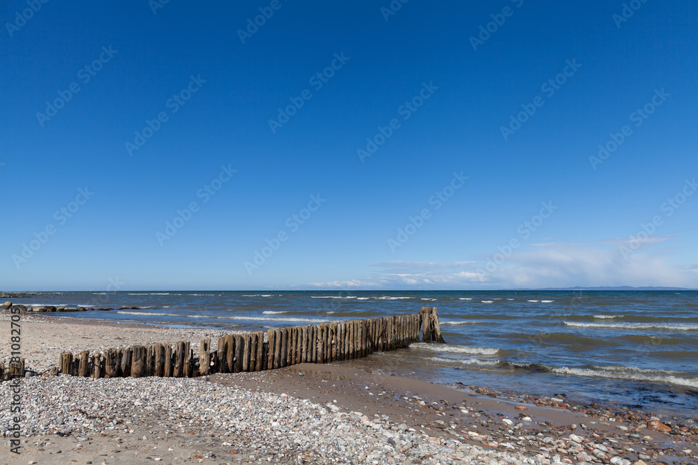 Wooden Wave Breaker on European Beach Coast Wooden Wave Breaker on European Beach Coast