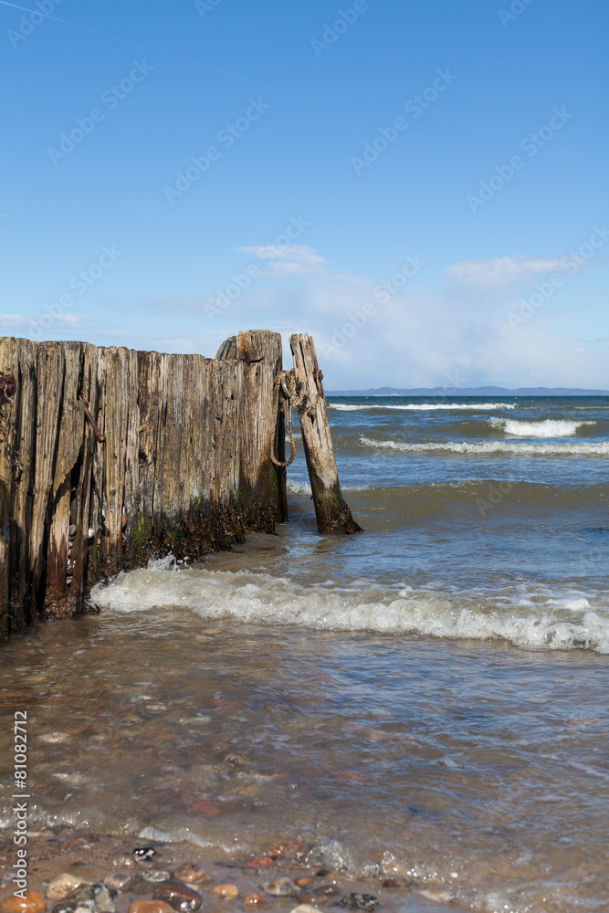 Wooden Wave Breaker on European Beach Coast Wooden Wave Breaker on European Beach Coast