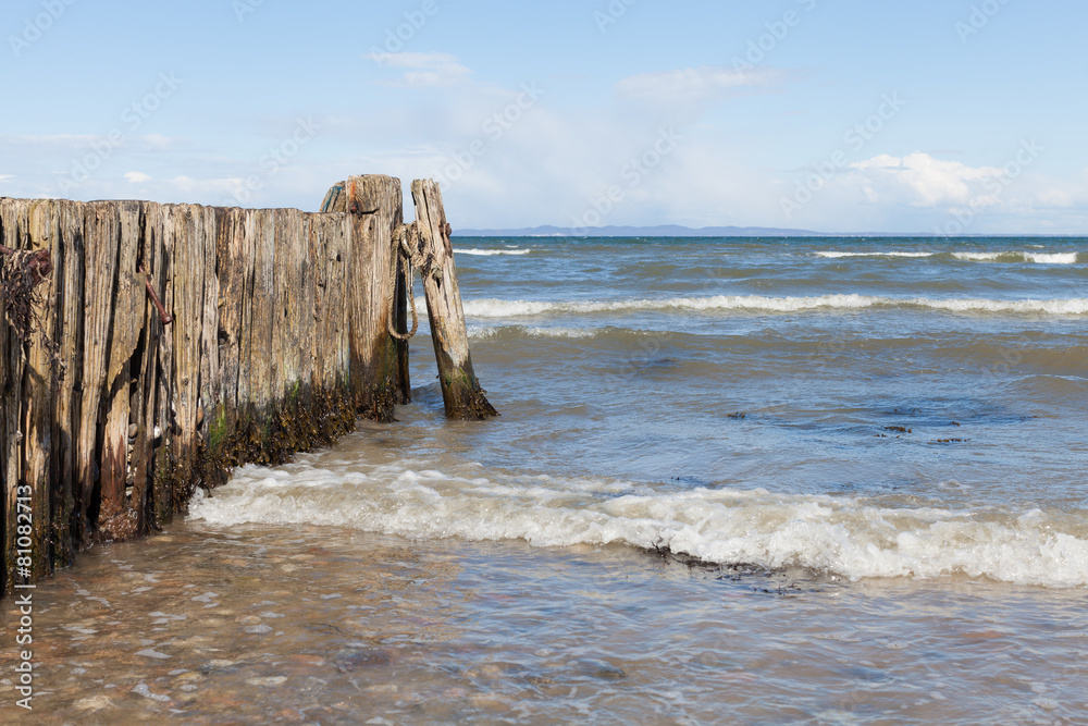 Wooden Wave Breaker on European Beach Coast Wooden Wave Breaker on European Beach Coast