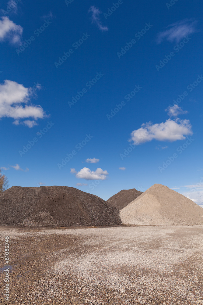 Piles of Gravel at Construction Site under Bright Blue Sky
