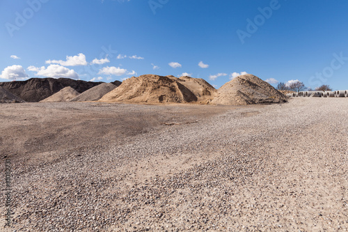 Piles of Gravel at Construction Site under Bright Blue Sky