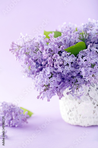 White vase with a bouquet of lilacs