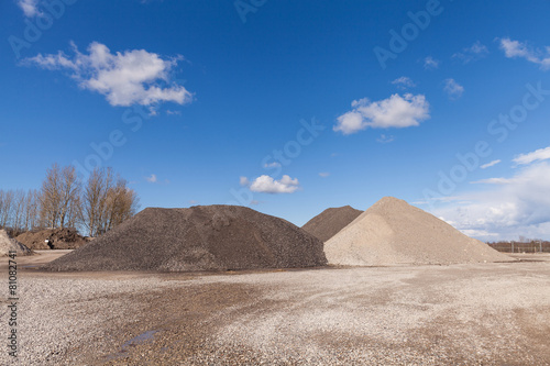 Piles of Gravel at Construction Site under Bright Blue Sky