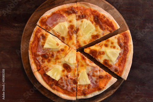 Hawaiian Pizza , pineapple , ham and cheese on wooden background