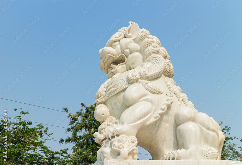 white lion stone carving under the sunlight