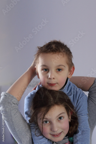 Family sister and brother pose embrace one another